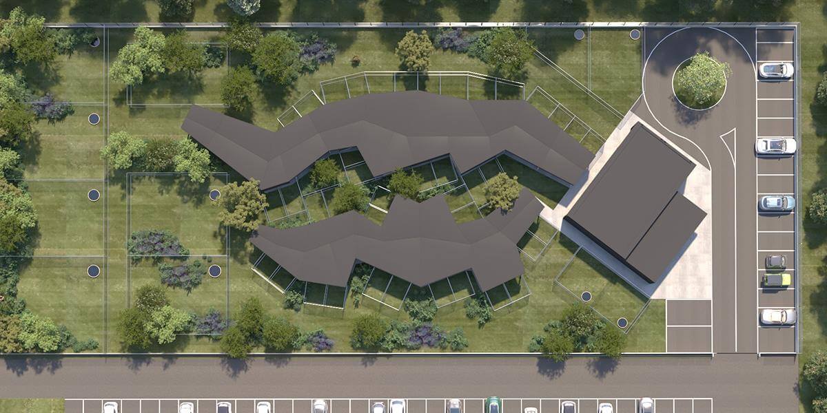 ista aérea del Dog Relais en el aeropuerto de Roma Fiumicino, con los lodges caninos rodeados de áreas verdes y zonas de recreo, parte del primer hotel para perros en un aeropuerto