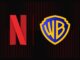 Logos de Netflix y Warner Bros sobre un fondo oscuro, representando la adquisición corporativa en la que Netflix compró Warner Bros