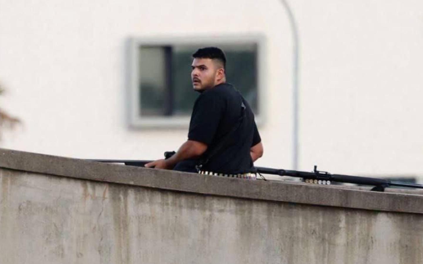 Hombre armado observado desde un edificio durante el operativo policial tras el tiroteo ocurrido en Bondi Beach, Australia